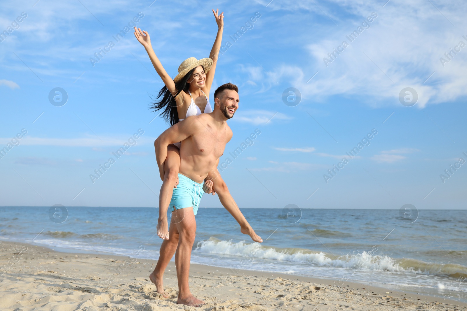 Photo of Happy young couple having fun on beach