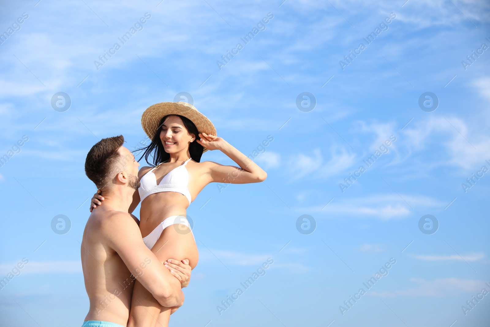 Photo of Happy young couple having fun on sunny day. Beach holiday