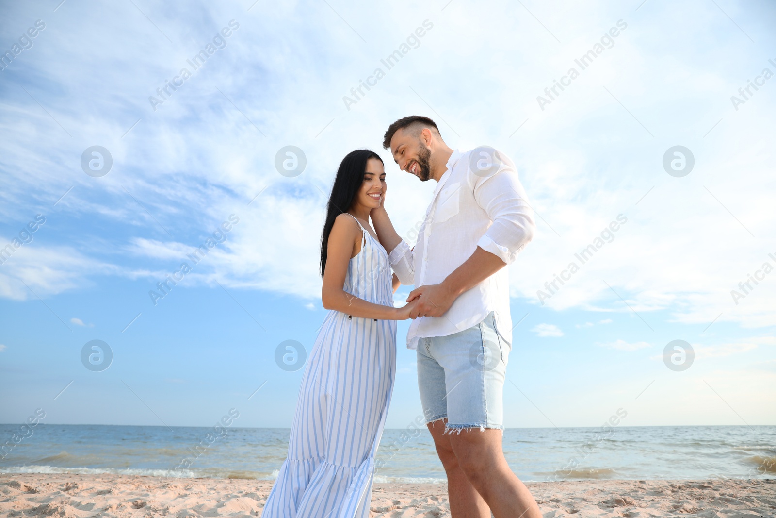 Photo of Happy young couple at beach on sunny day