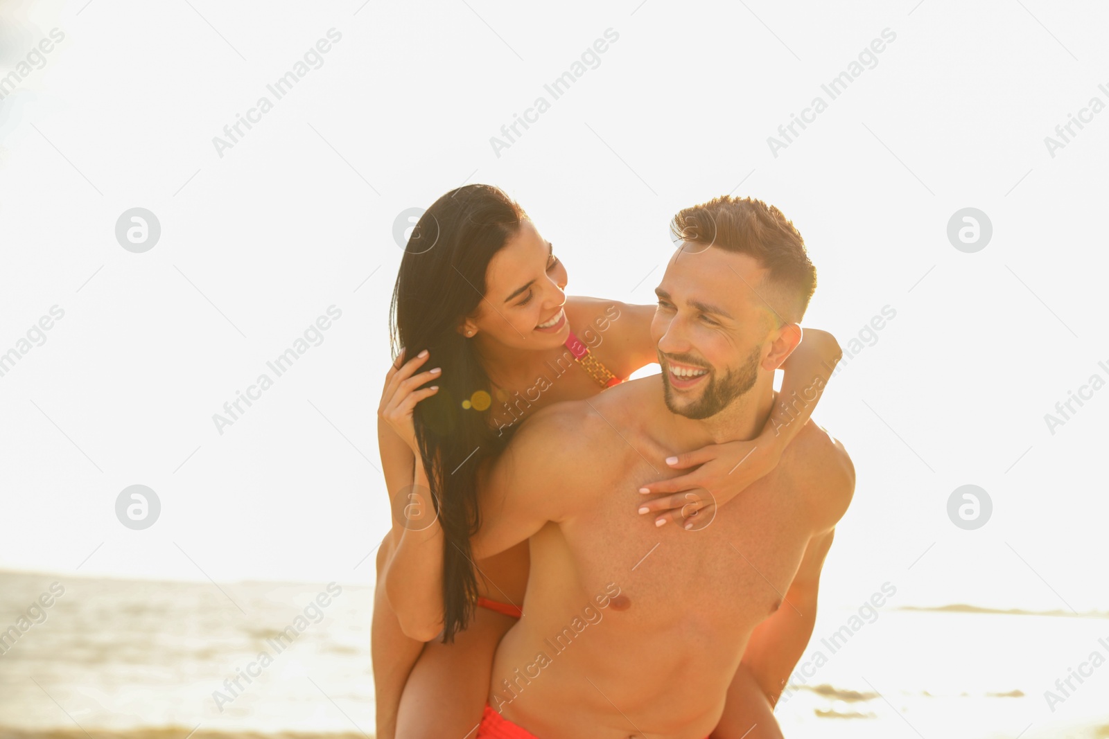 Photo of Happy young couple having fun on beach on sunny day