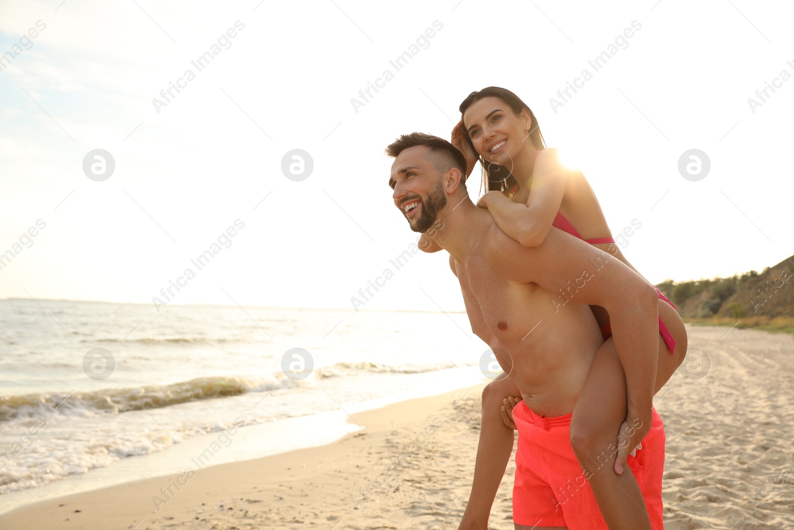 Photo of Happy young couple having fun on beach on sunny day