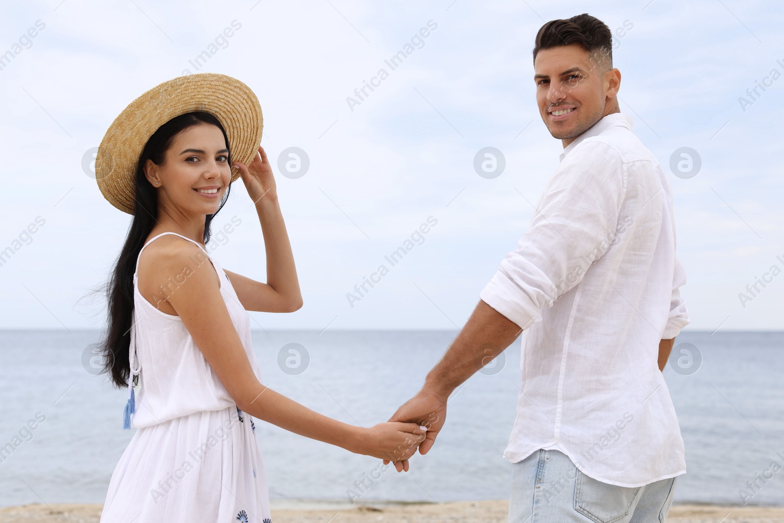 Photo of Lovely couple spending time together on beach