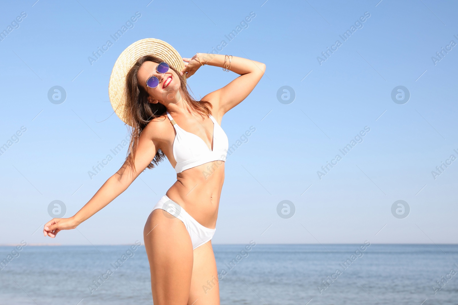 Photo of Young woman with beautiful body on beach