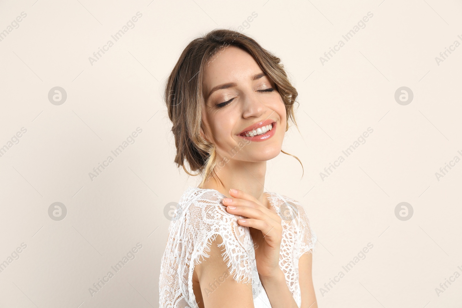 Photo of Young woman with beautiful hairstyle on beige background