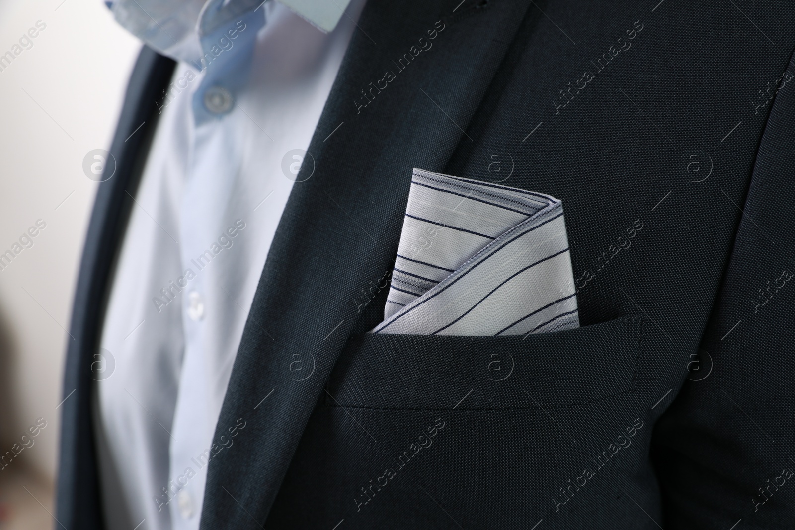 Photo of Man with handkerchief in suit pocket on blurred background, closeup