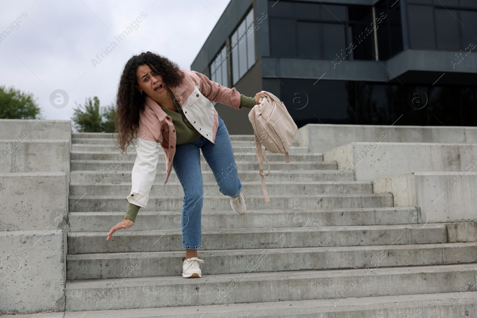 Photo of Woman falling on stairs outdoors. Dangerous accident