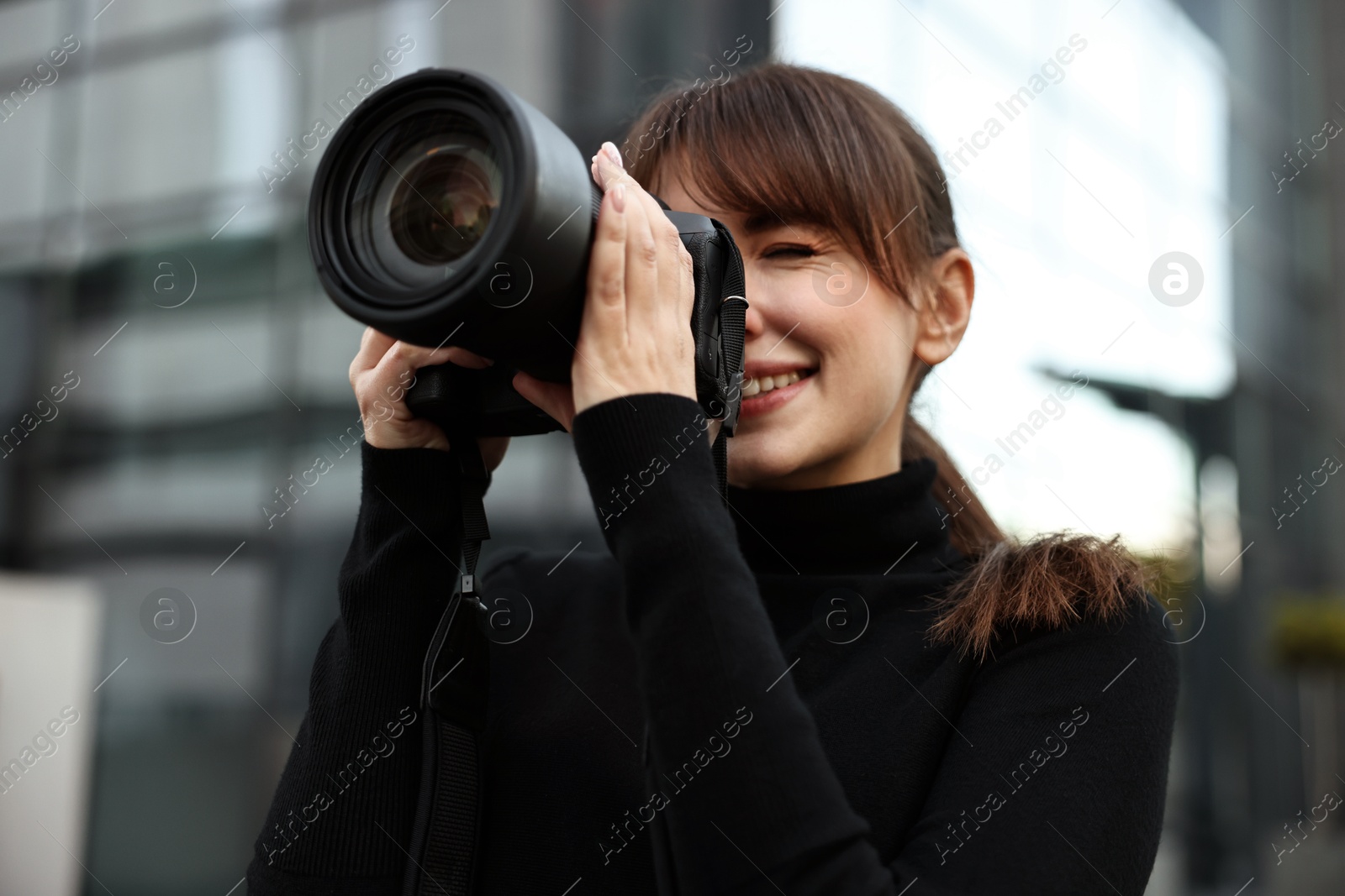 Photo of Professional photographer taking picture with camera outdoors