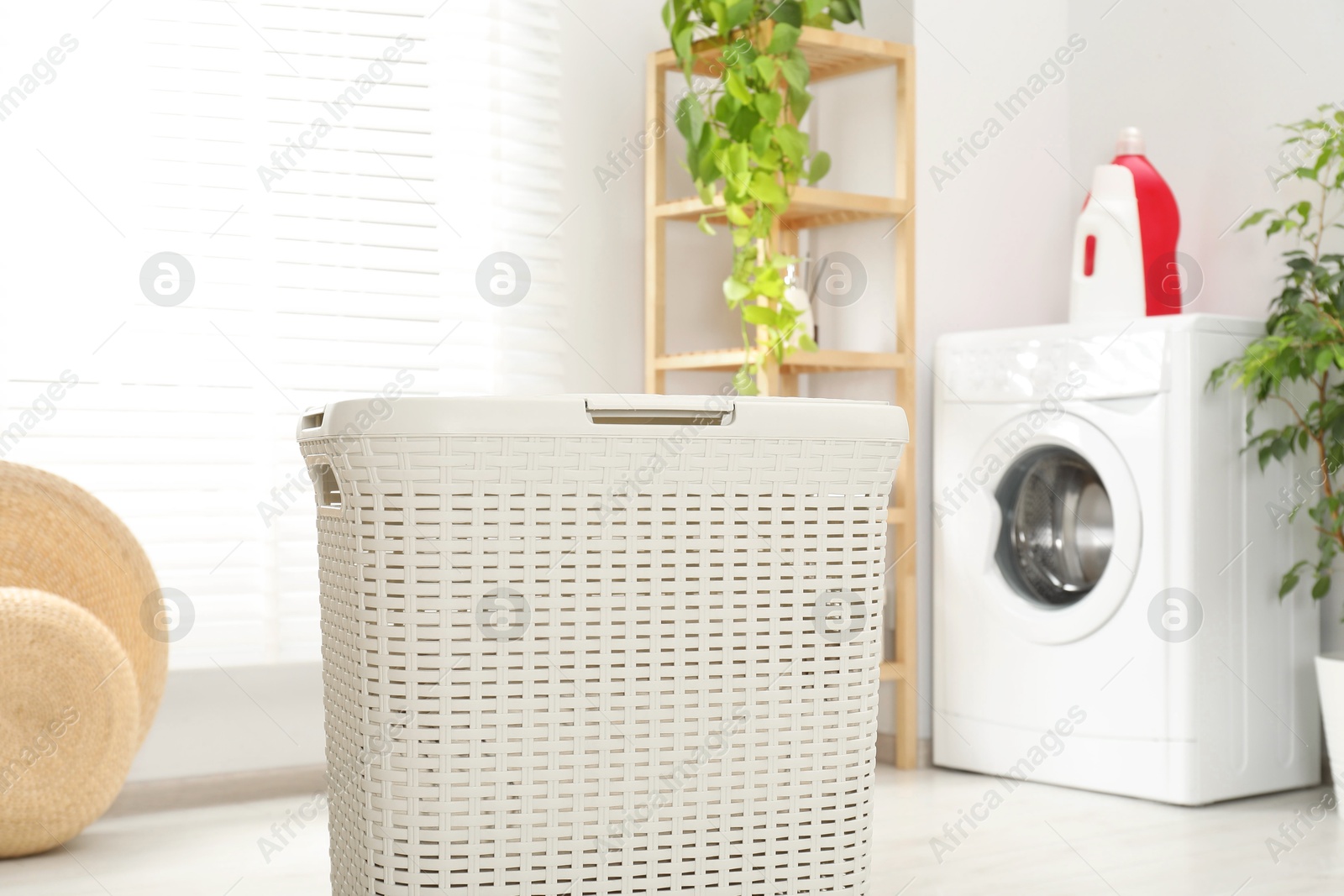 Photo of Wicker laundry basket on floor in bathroom