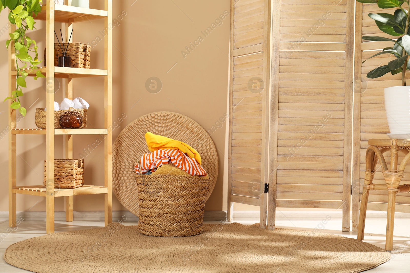 Photo of Wicker basket full of laundry in bathroom