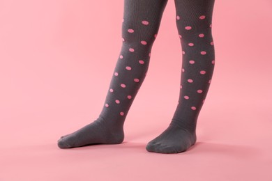 Photo of Child wearing tights on pink background, closeup