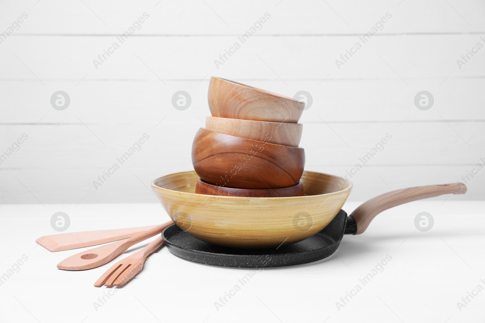 Photo of Dishware and cooking utensils on white table