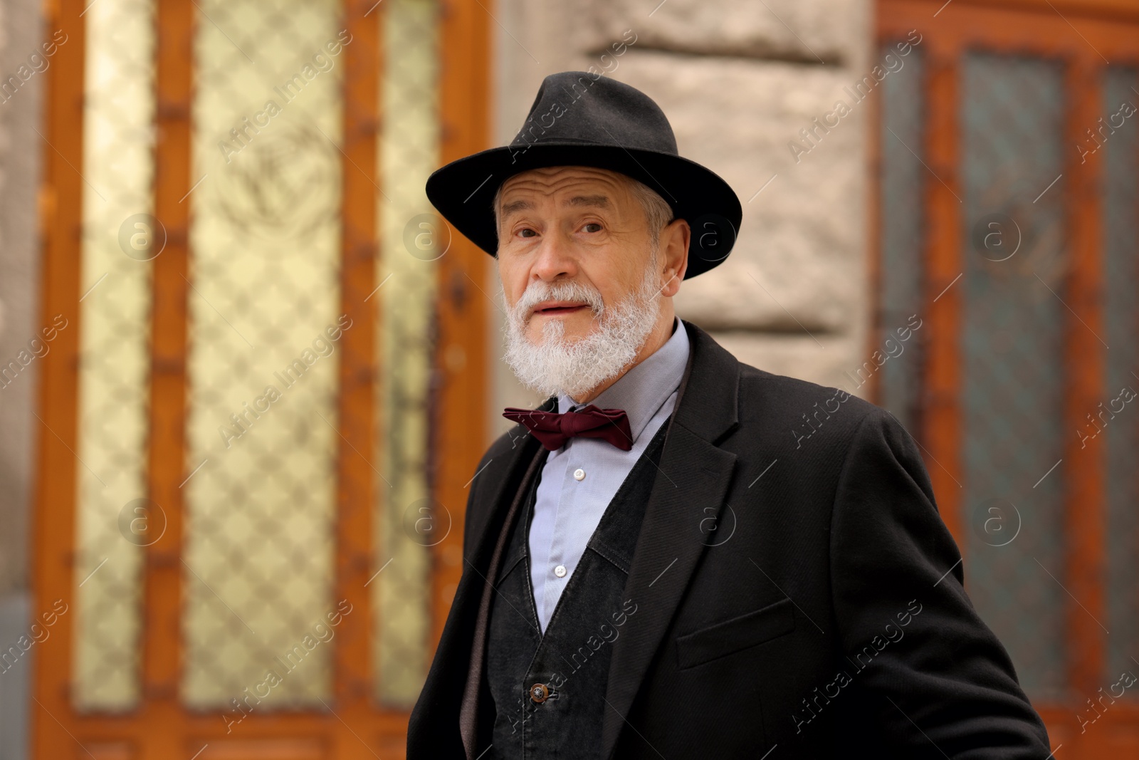 Photo of Bearded senior man in elegant outfit outdoors