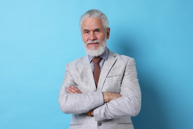 Photo of Portrait of senior man with gray beard on light blue background