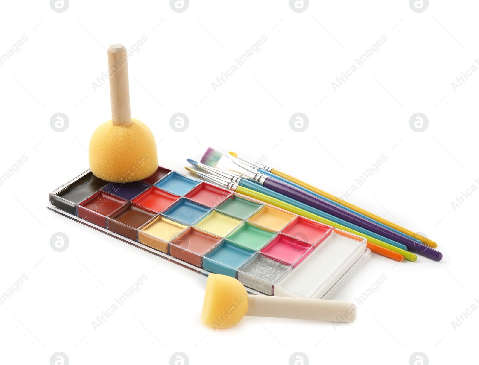 Photo of Bright face paint palette, brushes and sponges isolated on white