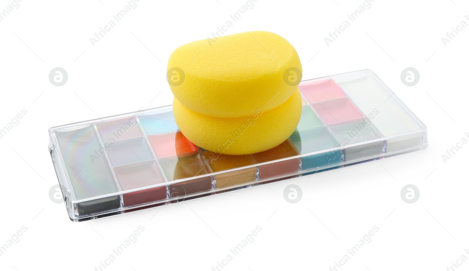 Photo of Bright face paint palette and sponges isolated on white