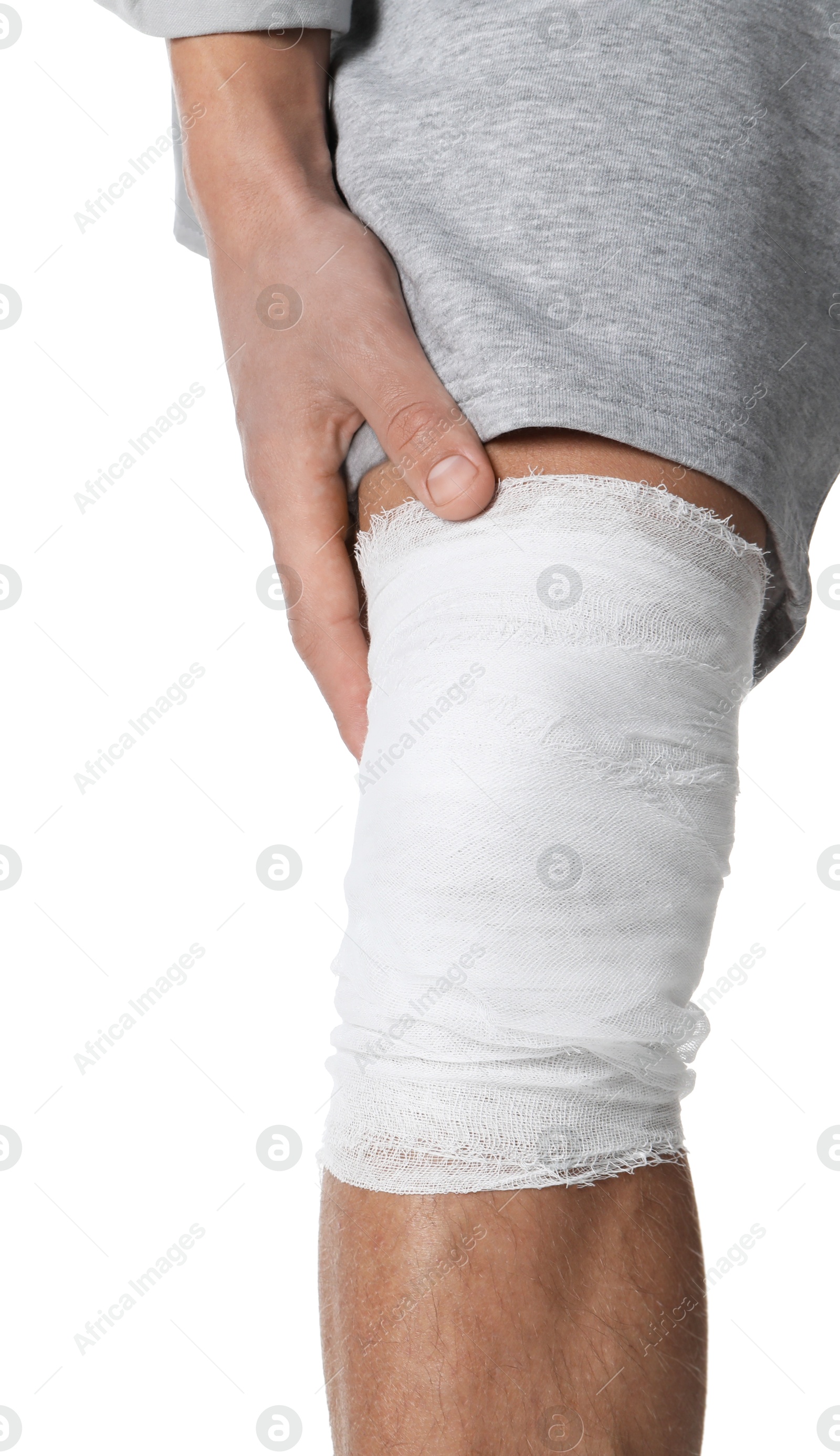 Photo of Man with medical bandage on his knee against white background, closeup