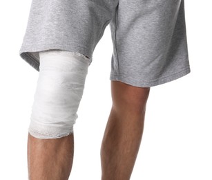 Photo of Man with medical bandage on his knee against white background, closeup