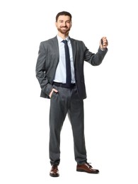 Photo of Cheerful salesman with car key on white background