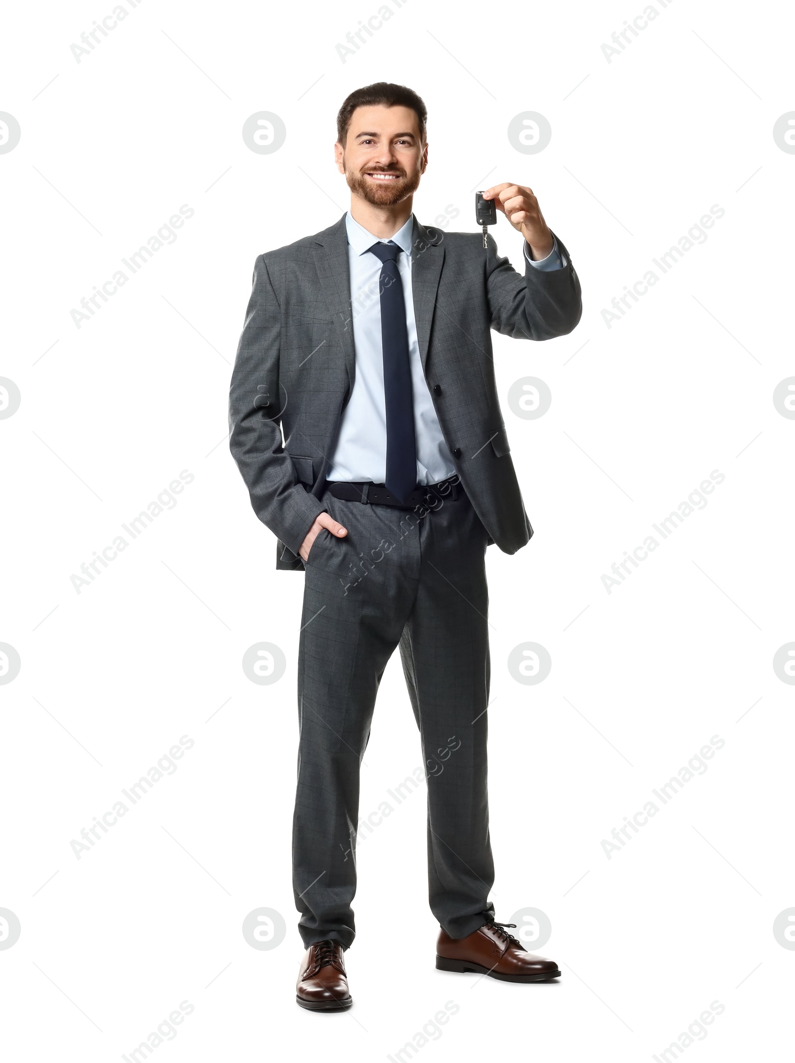 Photo of Cheerful salesman with car key on white background