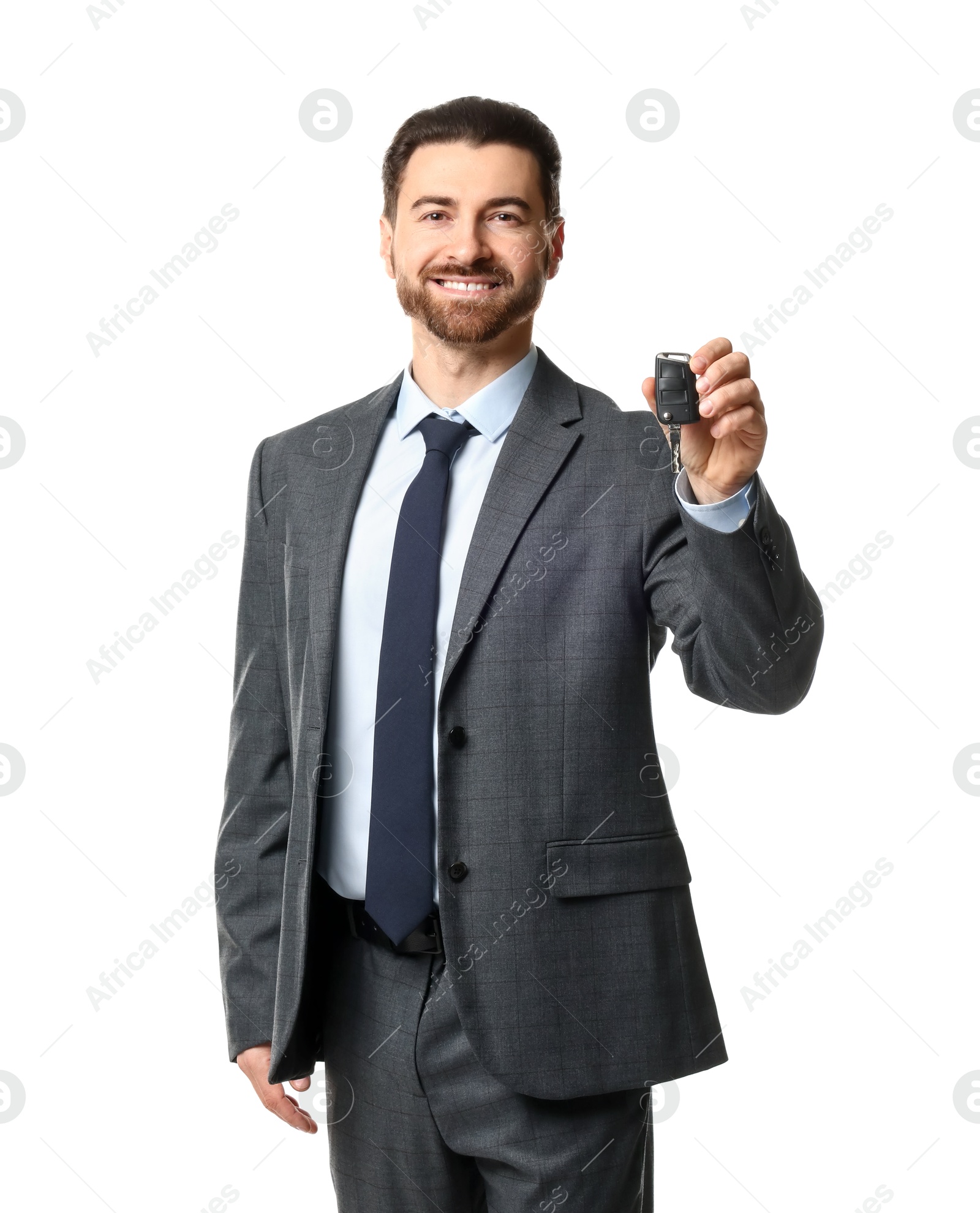 Photo of Cheerful salesman with car key on white background