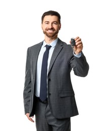 Photo of Cheerful salesman with car key on white background