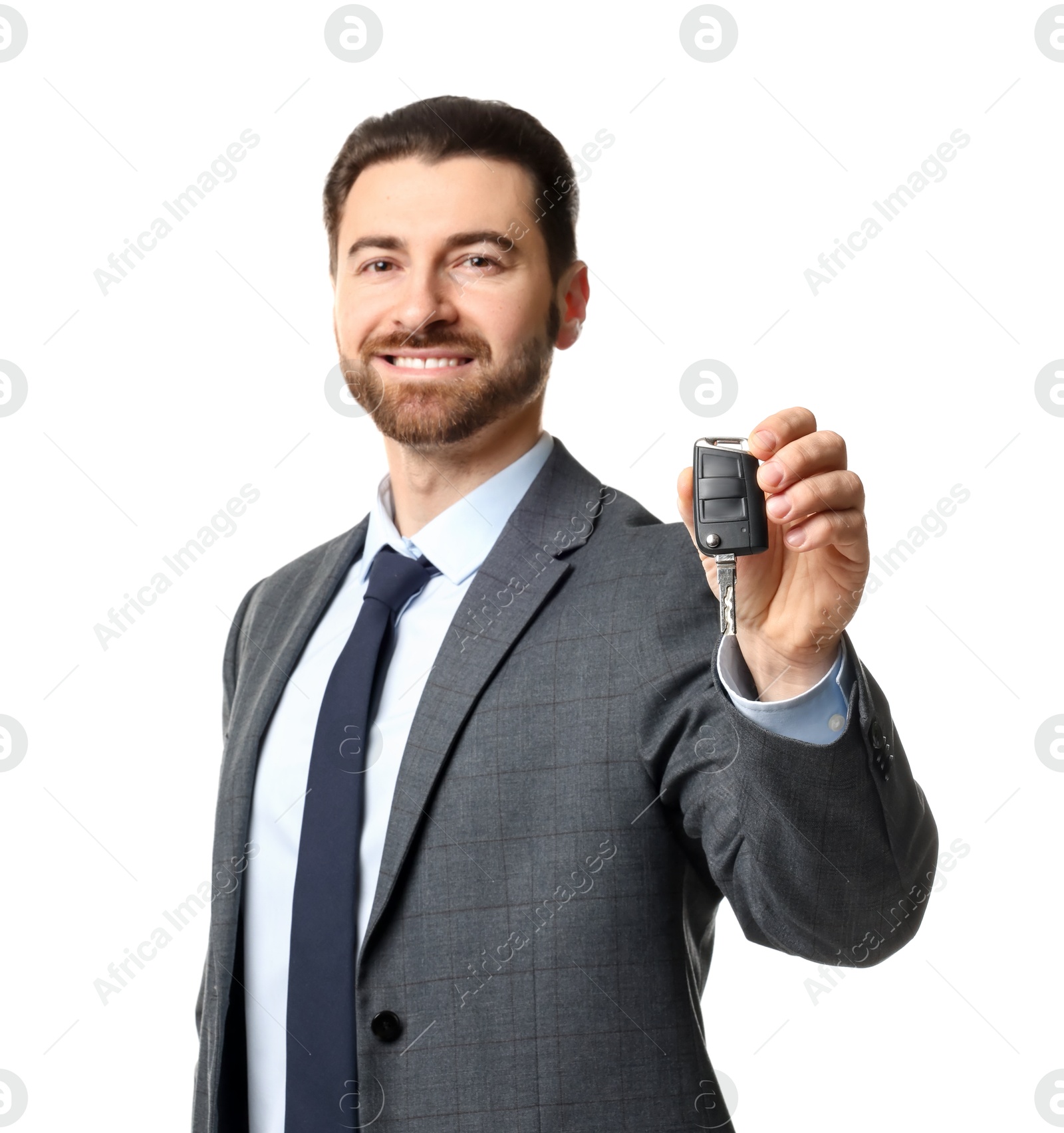 Photo of Cheerful salesman with car key on white background