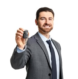 Photo of Cheerful salesman with car key on white background