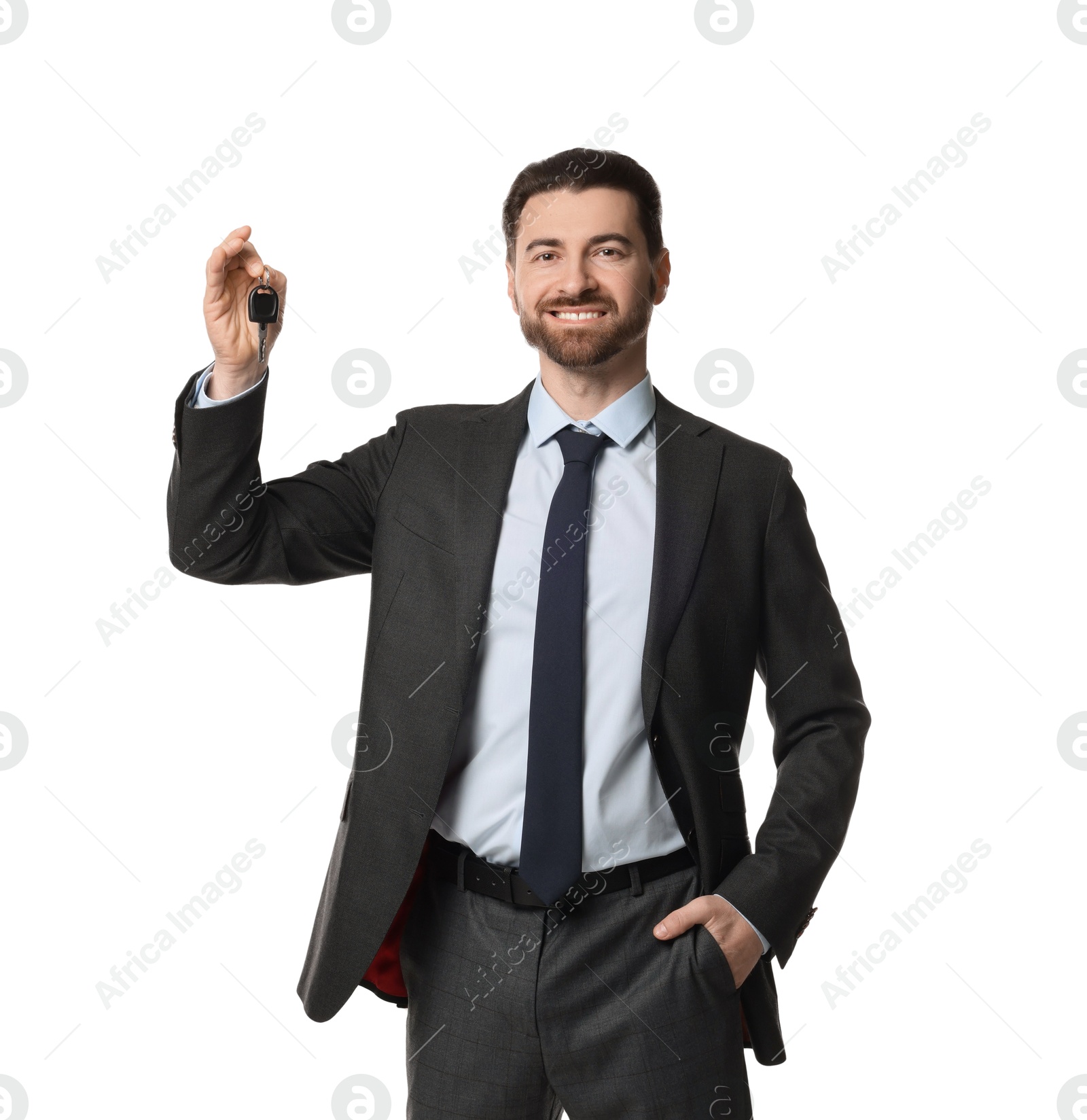 Photo of Cheerful salesman with car key on white background