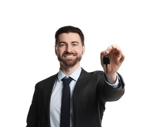 Photo of Cheerful salesman with car key on white background