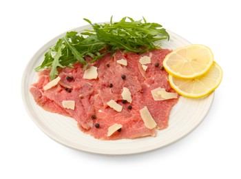 Photo of Fresh beef carpaccio with arugula, lemon and cheese isolated on white