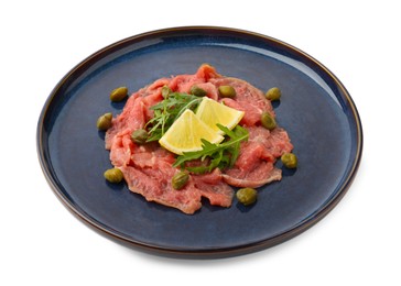 Photo of Fresh beef carpaccio with arugula, lemon and capers isolated on white