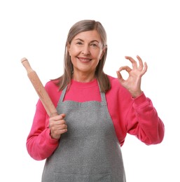 Photo of Happy woman with rolling pin showing ok gesture on white background