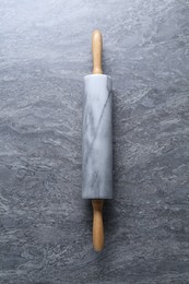 Photo of One rolling pin on grey textured table, top view