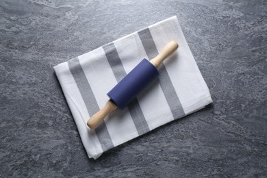 Photo of Rolling pin on grey textured table, top view