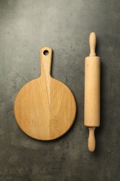 Photo of Wooden rolling pin and board on grey table, flat lay