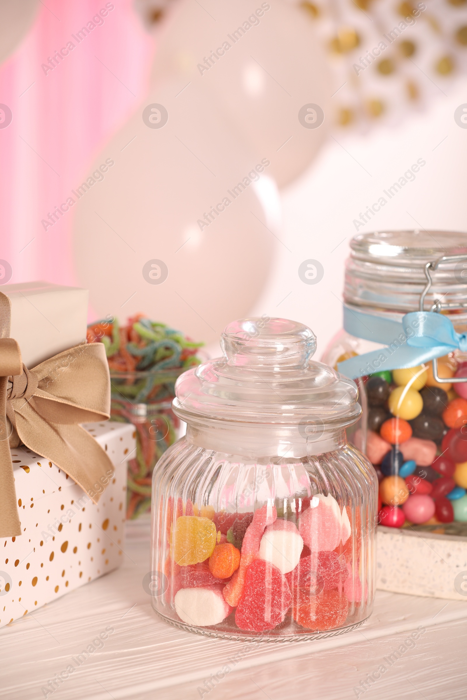 Photo of Candy bar. Many different sweets and gift boxes on white wooden table indoors