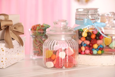 Photo of Candy bar. Many different sweets and gift boxes on white wooden table indoors