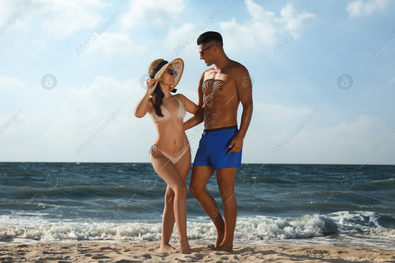 Photo of Lovely couple spending time together on beach