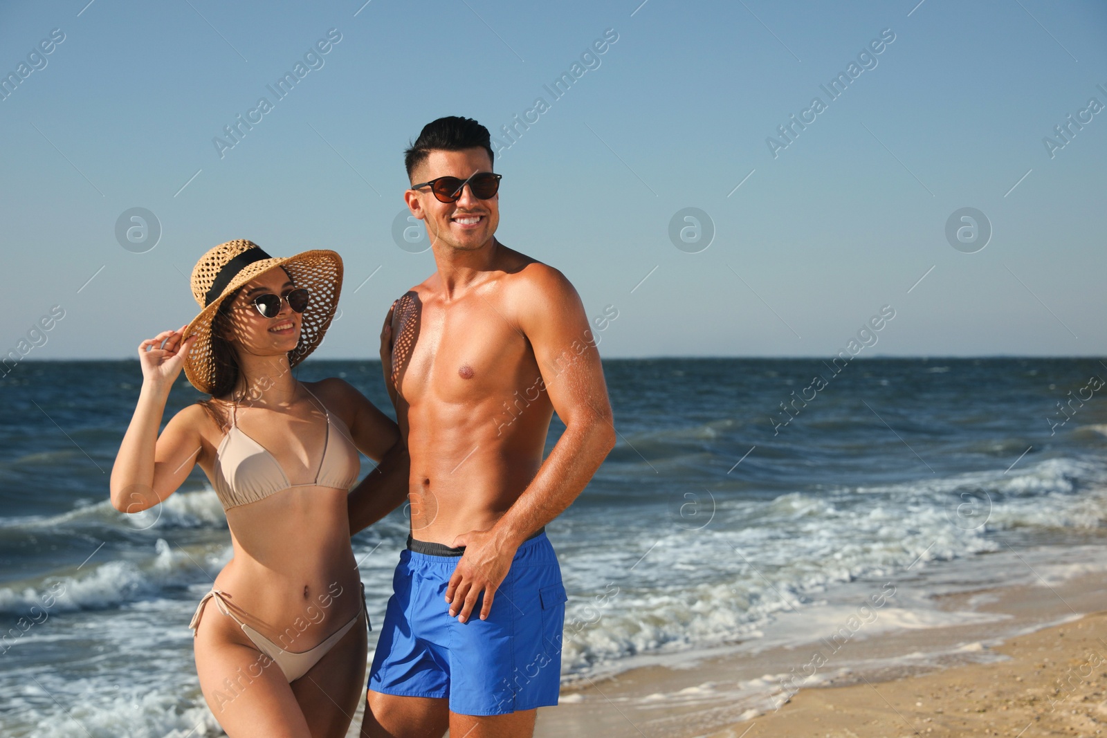 Photo of Lovely couple spending time together on beach