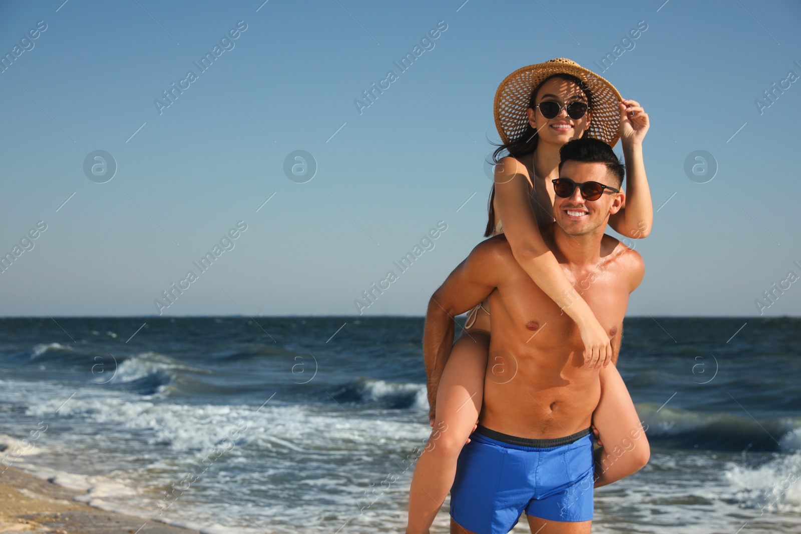 Photo of Lovely couple spending time together on beach