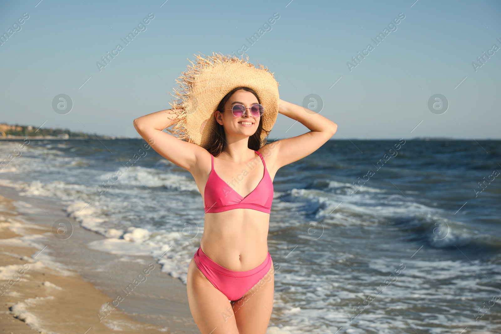 Photo of Beautiful young woman with attractive body on beach