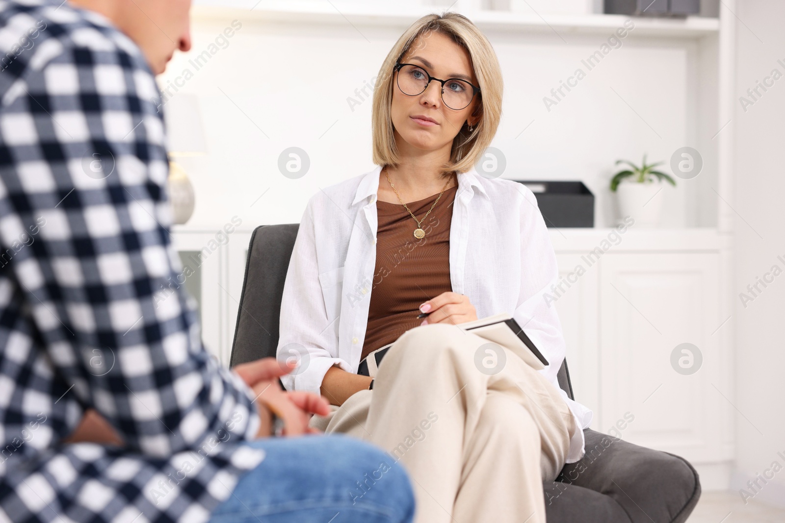 Photo of Professional psychologist working with patient in office