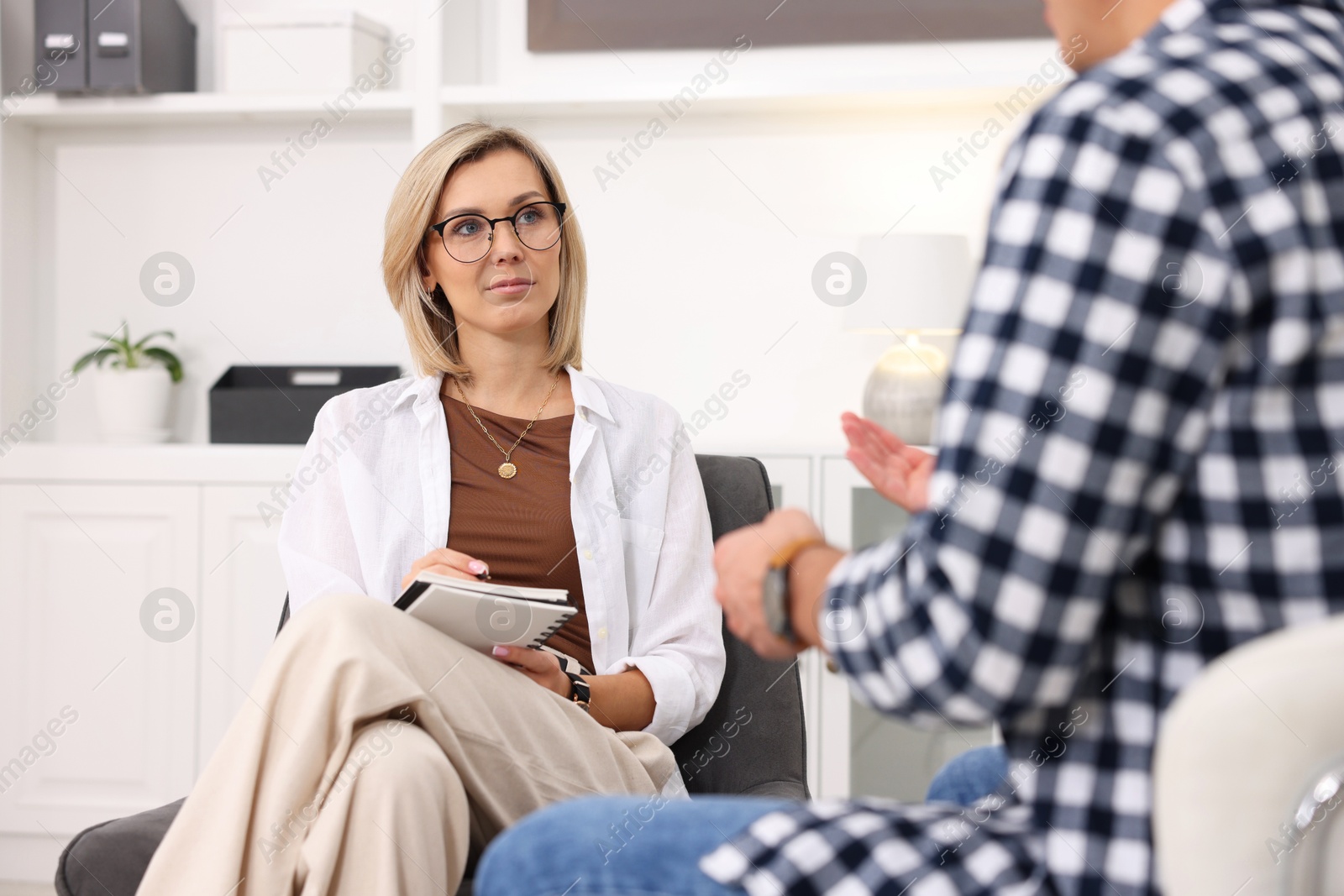 Photo of Professional psychologist working with patient in office