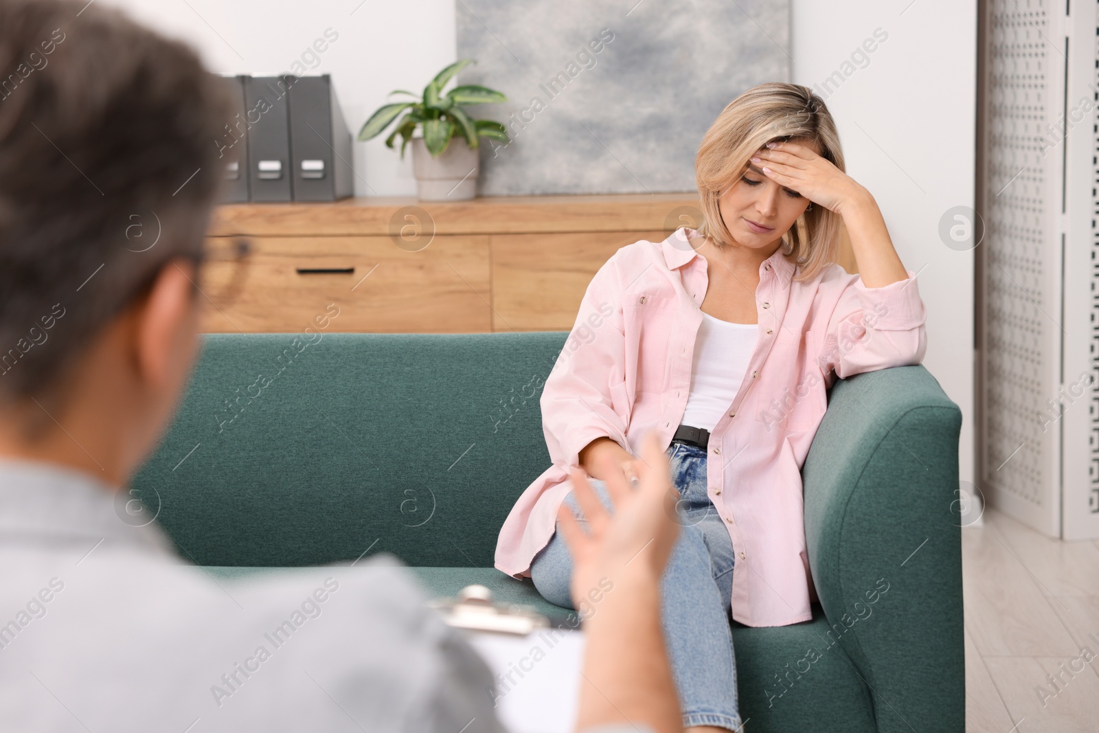 Photo of Professional psychologist working with patient in office, closeup