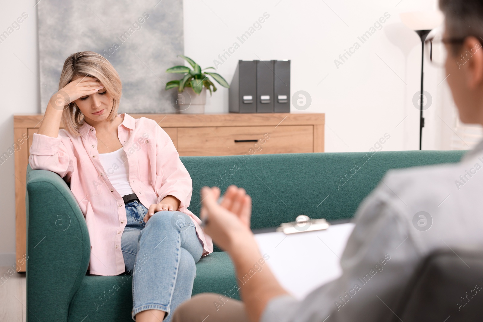 Photo of Professional psychologist working with patient in office, closeup