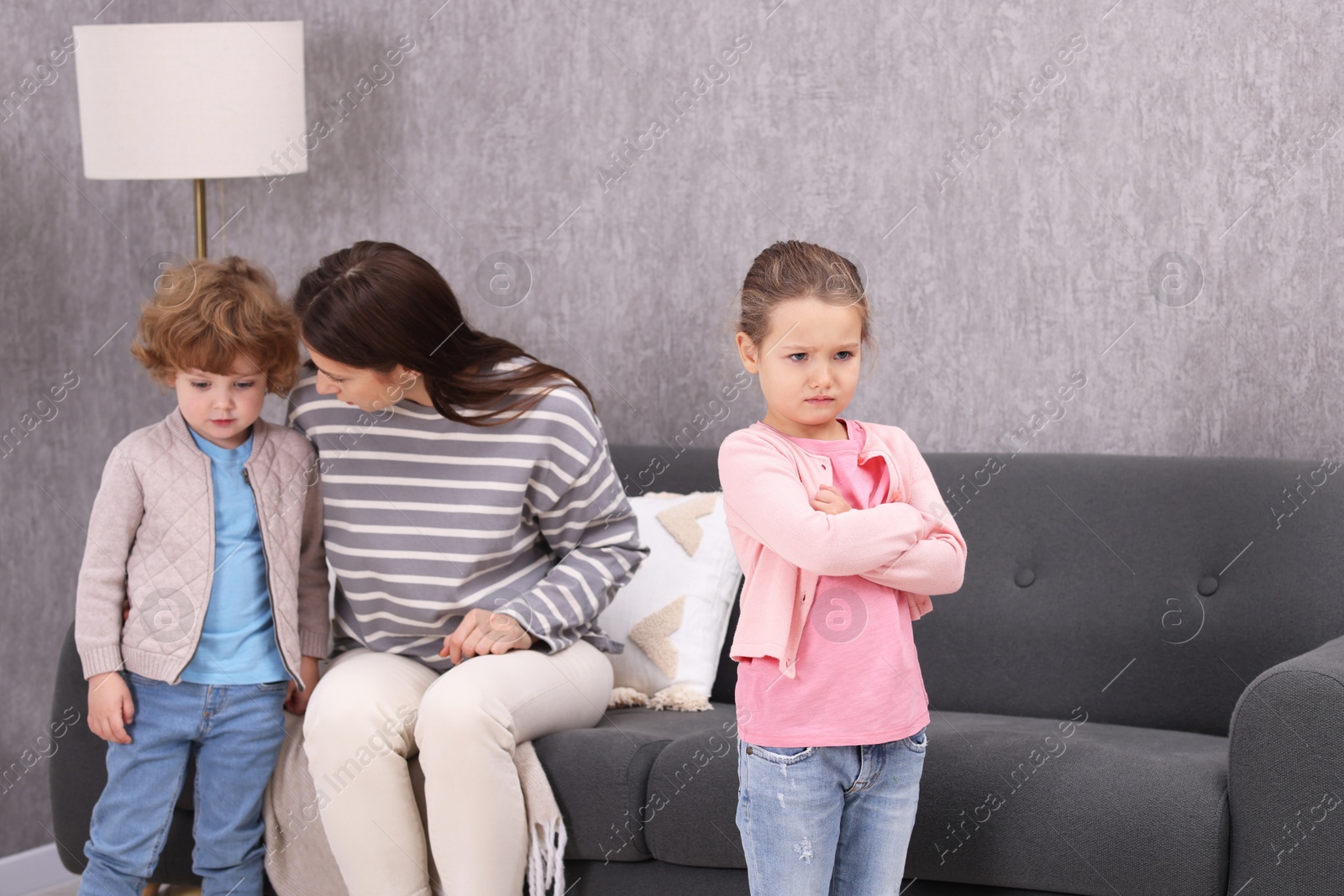 Photo of Resentful little kids and their mother arguing at home