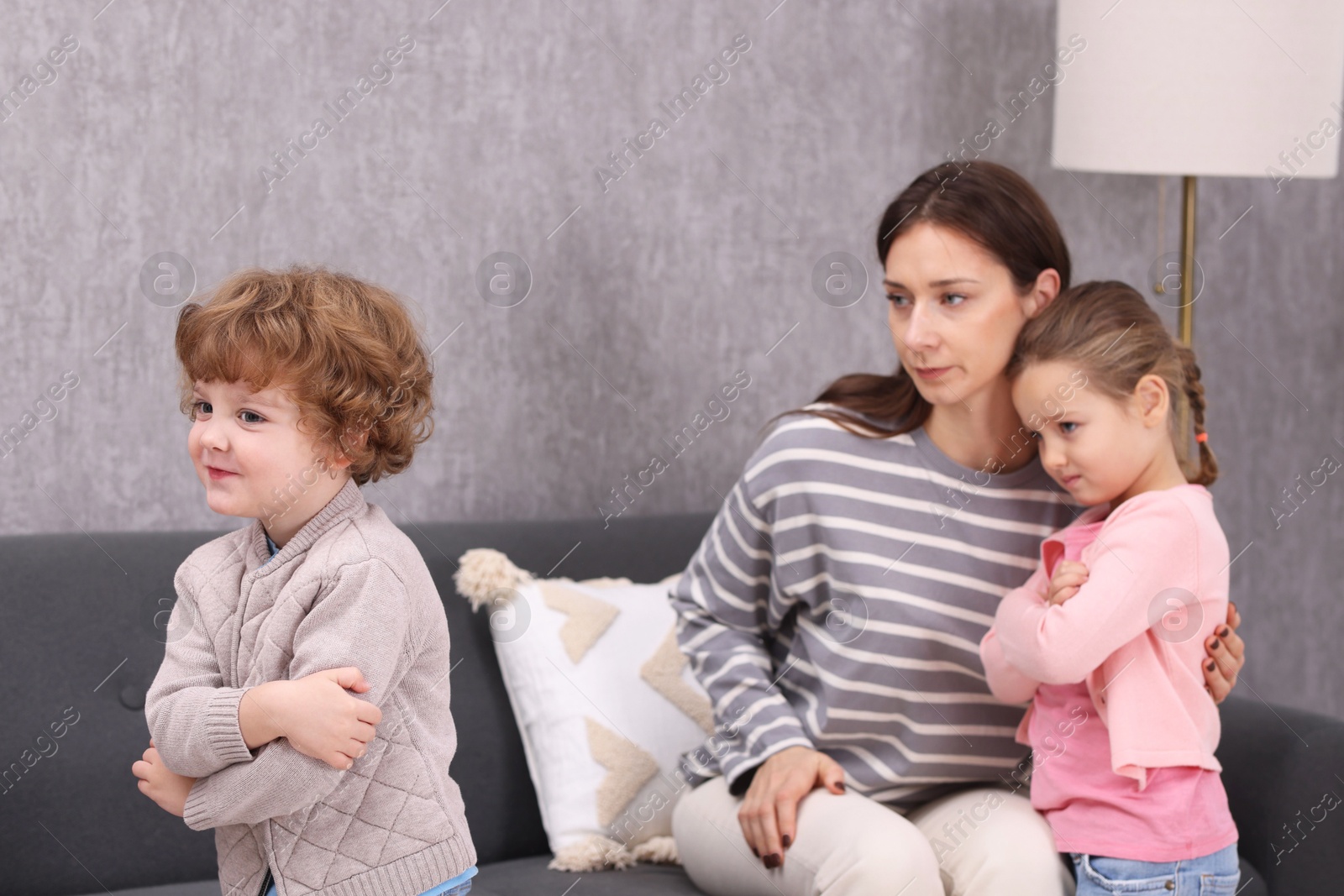 Photo of Resentful little kids and their mother arguing at home