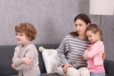 Photo of Resentful little kids and their mother arguing at home