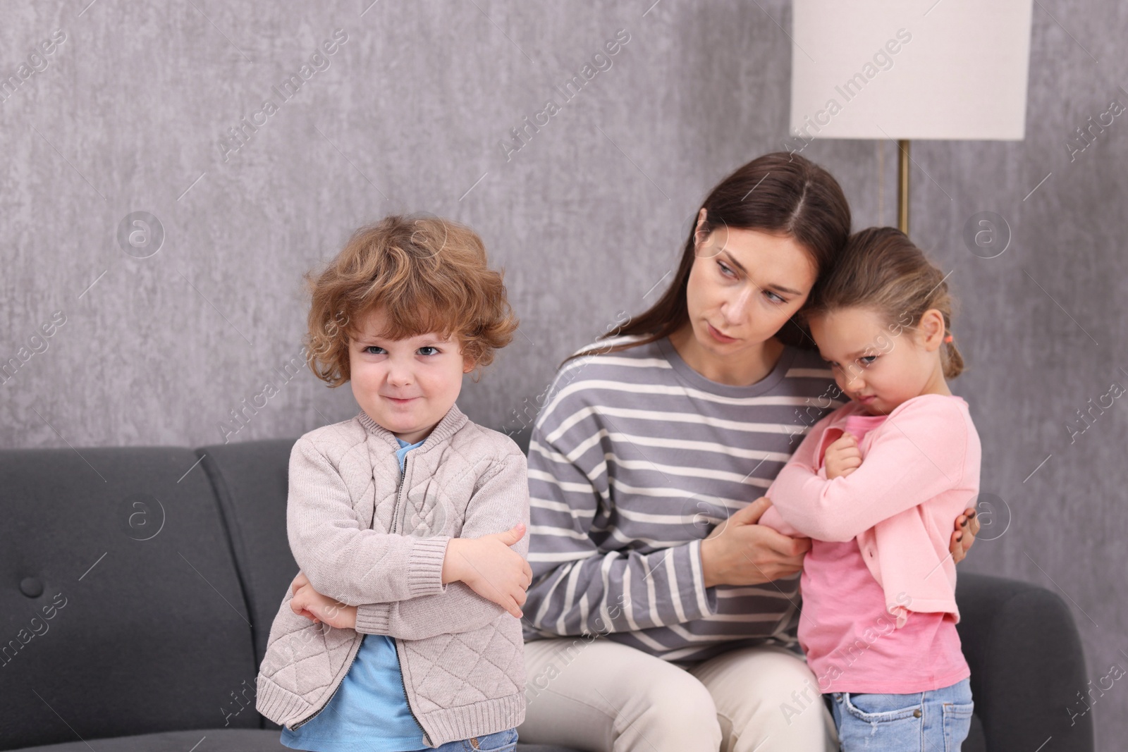 Photo of Resentful little kids and their mother arguing at home