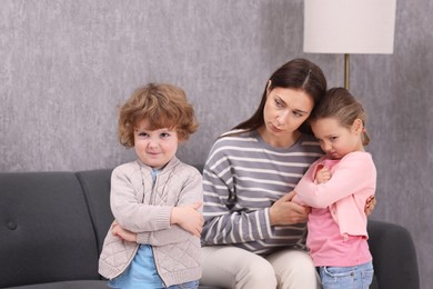 Photo of Resentful little kids and their mother arguing at home